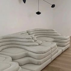 an inflatable couch sitting on top of a hard wood floor next to a white wall