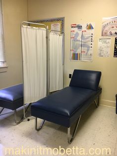 a hospital room with a bed, chair and other medical supplies on the wall next to it