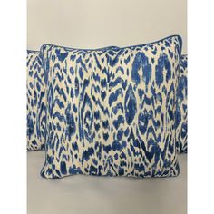 two blue and white pillows with an animal print pattern