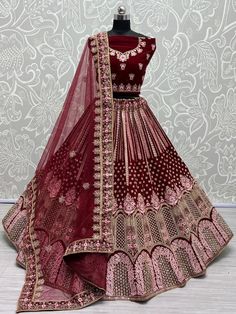 It's your special day, and we have the perfect outfit to make you look as beautiful as you feel. Introducing the "Dazzle Maroon Thread Work Velvet Bridal Lehenga Choli" from Ethnic Plus, a stunning ensemble that will leave everyone in awe.
Designed with meticulous attention to detail, this lehenga set features a heavy velvet lehenga and choli in a charming maroon color. The rich velvet fabric not only adds a touch of luxury but also provides a flattering silhouette, making you feel like a true p Velvet Bridal Lehenga, Pink Bridal Lehenga, Red Lehenga Choli, Velvet Lehenga, Reception Lehenga, Lengha Choli, Pink Lehenga, Lehenga Choli Online, Red Lehenga