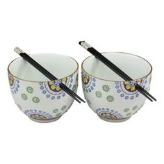 two bowls with chopsticks in them sitting next to each other