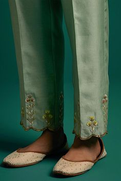 Green kurta with placed thread floral embroidery and scalloped edges. Comes with matching pant.
Components: 2
Pattern: Embroidered
Type Of Work: Floral,Sequin
Neckline: Round
Sleeve Type: Full
Fabric: Silk Chanderi
Color: Green
Other Details: 
Model Height: 5ft 6inches wearing size S
Closure: Kurta: Front hook
Occasion: Mehendi and Haldi - Aza Fashions Summer Chanderi Sets With Intricate Embroidery, Spring Cotton Traditional Wear With Gota Work, Spring Traditional Cotton Wear With Gota Work, Pista Green Sets With Gota Work For Summer, Spring Cotton Traditional Wear With Embroidered Border, Eid Cotton Bottoms With Embroidered Border, Elegant Spring Traditional Wear With Gota Work, Festive Embroidered Border Pants For Diwali, Summer Floral Embroidery Pista Green Sets