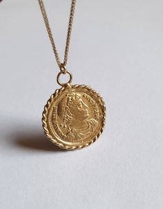 Solid gold coin necklace, 14k gold necklace, coin pendant necklace, medallion necklace, coin necklace, gold pendant necklace An old Greek coin, made of solid gold which was duplicated and wrapped with twisted gold wires to make a beautiful medallion pendant. The antique coin is not a perfect circle in shape and a little rustic. The necklace is available in gold filled, sterling silver, 9k and 14k solid gold. You can also purchase the pendant only if you wish. This 14k gold coin necklace is great Coin Necklace Gold, Necklace Gold Pendant, Perfect Circle, Simple Bangle, Gold Coin Necklace, Antique Coins, Coin Pendant Necklace, Medallion Necklace, 14k Gold Necklace