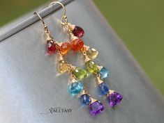 Playful rainbow earrings full of amazing colors and perfect stones in different shapes: including Amethyst, Padparadscha Sapphire, Citrine, Peridot, Topaz Kyanite and Amethyst. Beautiful Multi Gemstone earrings that combine unique gems and colorful design! ⭐ DETAILS: ✓ Length of the earrings including earwires: 2.2″ (~5.6 cm) ✓ Gold: High quality 14K Gold Filled ✓ Silver: [...] Amazonite Earrings, Blue Gemstone Earrings, Gemstone Earrings Gold, Gemstone Drop Earrings, Rainbow Gemstones, Padparadscha Sapphire, Solid Gold Earrings, Rainbow Earrings, Opal Bracelet