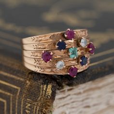 Harem rings come to us from the Victorian era, with a few different theories as to how they came into existence. They are made from 5 smaller bands. All mechanically joined together to create one wider band, often dotted with baby gemstones for a “confetti” appearance. Ours is in vintage rose gold, with the juiciest and brightest little gemstones! This ring is perfect for one who loves to fidget and play with their jewelry - the bands all individually hinge and move around in the most fun way. 1 Vintage Round Band Stackable Rings, Vintage Multi-stone Birthstone Promise Ring, Heirloom Style Stackable Emerald Ring, Heirloom Birthstone Ring With Round Band, Heirloom Multi-stone Stackable Rings For Wedding, Heirloom Style Multi-stone Stackable Wedding Rings, Heirloom Multi-stone Stackable Wedding Rings, Vintage Birthstone Rings With Round Band, Heirloom Multi-stone Round Band Rings