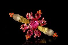 "This is a very beautiful and unique TRIFARI STYLE RHINESTONE ART GLASS METAL pin brooch. The pin has a marvelous shape with faux coral, art glass cabochons, pink rhinestone and gold tone metal. The brooch is in fantastic quality. The bottom is unmarked. The pin has a very extravagant and elegant feel to it. It measures 4\" x 2 1/2\". The pin is in very good condition. 0.7 D00502008" Pink Evening Jewelry Brooch, Pink Sapphire Brooch, Pink Vintage Evening Brooches, Pink Ruby Flower-shaped Jewelry, Vintage Pink Collectible Brooches, Filigree Ring Gold, Coral Art, Vintage Trifari, Garnet And Gold