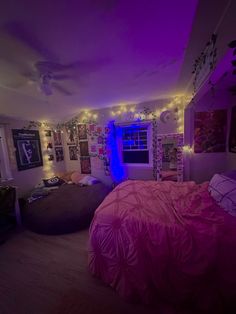 a bedroom with purple lights and pictures on the wall above the bed, along with a bean bag chair