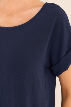 Elevate your wardrobe with our Elevated Classic Navy Short Sleeve Top. This versatile piece is perfect for any occasion. With its elevated and unique design, you'll stand out from the crowd while feeling comfortable and confident. Grab yours today and experience the perfect blend of style and comfort. This top features a crew neckline, a folded cuff sleeve, and an intentional back seam detail. 100% Polyester Hand Wash Cold Unlined Imported Model is wearing a size small Casual Navy Summer T-shirt, Navy Short Sleeve Tops For Loungewear, Casual Summer T-shirt With Curved Hem, Navy Summer T-shirt, Navy Crew Neck Top For Summer, Summer Cotton T-shirt With Curved Hem, Casual Navy Tops For Loungewear, Cotton T-shirt With Curved Hem For Summer, Casual Cotton Tops With Curved Hem