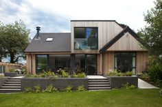 a house that is made out of wood and brick with stairs leading up to it