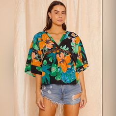 Our 'Flower Tunic' Has A Relaxed Fit With Gorgeous Details And Colorful Print Throughout. A Summer Statement & Staple. Pretty Crochet Detail At Under Bust In Size Small. Pretty Crochet, Tropical Flower, Crochet Details, Tropical Flowers, Black Green, Colorful Prints, Ruffle Blouse, Relaxed Fit, Womens Tops