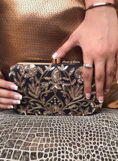 This is a beautiful handcrafted clutch bag made with love.It has intricate handwork which showcases the Indian craftsmanship by our local artisans. It comes with a metal sling chain. Details  - Single side handwork  - Fabric lining on the inside to keep your belongings safe  - Metal lock closure  - Detachable sling chain  This clutch can be worn as a crossbody bag or a shoulder bag with the sling chain or can simply be carried in hand.It is spacious enough to carry mobile phones, lipsticks, Keys Embroidery Clutch, Asian Gifts, Wedding Accessory, Black Embroidery, Luxury Bag, Bride Gift, South Asian, Designer Bag, Small Accessories