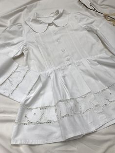 Amazingly detailed vintage 40's/50's blaser or blouse with extreme puff sleeves, peplum and cotton buttons, petern pan collar and cut out lace richelieau with roses. Goes well with an understated crop top and high waisted jeans. Very Rouje-esque, but Eastern European + original. Sits a size small to large. Measurements soon. Excellent condition, rare piece. Fitted Summer Blouse With Doll Collar, Summer Fitted Blouse With Doll Collar, Bishop Sleeve Tops With Buttons For Summer, Victorian Cotton Fitted Blouse, Fitted Victorian Cotton Blouse, Spring Puff Sleeve Top With Lace Patchwork, Puff Sleeve Tops With Lace Patchwork For Spring, Spring Fitted Top With Doll Collar, Fitted Tops With Doll Collar For Spring