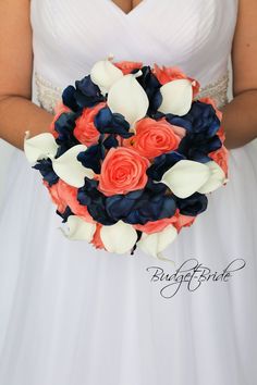 a bride holding a bouquet of flowers in her hands and wearing a white dress with blue, orange and pink accents