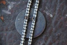 "31\" Black and White Woven Cordage Bolo tie Bronze Tone 1877 Indian Head Penny Replica Slide. This bolo tie is in great shape. It is 31\" long x 3/16\" woven black and white vinyl cordage. The slide is 1 3/4\" in diameter. The tips are gold tone. This is one worth passing down through the generations Metal has a fantastic patina Thanks for looking! jewelry" Vintage Lariat Bolo Tie For Ranch, Vintage Lariat Bolo Ties For Ranch, Vintage Bolo Ties With Adjustable Length For Rodeo, Vintage Bolo Tie For Ranch, Vintage Style Concho Lariat Necklace, Vintage Concho Lariat Necklace, Vintage Lariat Bolo Ties For Rodeo, Western Bolo Tie, Bolo Ties