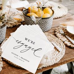 there is a table set with place cards and silverware on top of the table