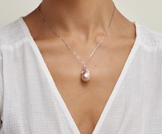 This pendant features a gorgeous pink 15mm high quality Freshwater Baroque pearl, hand picked for its luster and unique overtones. The pearl is mounted on the finest 14K 18" gold chain with circular bail at the top. The pendant is packaged in a beautiful jewelry box, perfect for gifting. Elegant Pink Pearl Drop Necklace, Elegant Pink Pearl Necklace With Pendant, Elegant Pink Pear-shaped Necklace, Luxury Pink Necklace With Pearl Pendant, Luxury Drop Pearl Necklace For Gift, White Gold Pearl Pendant Necklace In Drop Shape, Pink Pearl Drop Necklace For Formal Occasions, Elegant Pink Pearl Pendant Necklace, Pink Pearl Charm Necklace For Formal Occasions