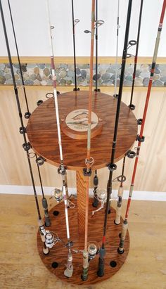 a wooden table topped with lots of fishing rods