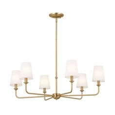 a chandelier with six lights and white shades on the bottom, in an antique brass finish