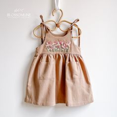 This adorable dress is perfect for little ones during the warm spring and summer days. Made of linen, a cool and comfortable material, the dress features a delicate and charming design with hand-embroidered flowers, adding a touch of craftsmanship and elegance. Features: Material: High-quality linen and cotton, ideal for keeping your little one cool and comfortable in the heat. Design: Beach dress in white, cream, and beige tones, combining simplicity and style. Details: Hand-embroidered flowers Cotton Sundress For Babies For Beach, Summer Beige Cotton Sundress, Beige Cotton Sundress For Summer, Beige Cotton Summer Sundress, Cute Linen Beach Dress, Beige Cotton Sundress, Casual Beige Embroidered Dress For Spring, Cute Linen Summer Dress, Embroidered Summer Sundress For Spring