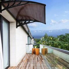 a balcony with wooden flooring and an awning