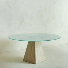 A 1960s Italian dining table featuring a triangular travertine pedestal base with elegant veining and a porous finish. It has a circular frosted glass tabletop with a bevel edge in a captivating blue hue. The top is supported by a chrome x-support attached to the base. Unmarked. Sourced in Italy, 1960s.  DIMENSIONS: 57.25"Dia x 30"H; Base: 18.75"W x 18.75"D x 29"H Travertine Pedestal, Travertine Dining Table, Italian Dining Table, Ceramics Pottery Bowls, Accent Seating, Free Standing Wall, Entry Tables, Italian Dining, Leaf Table