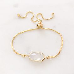 "DESCRIPTION: The SERENITY Bracelet - dainty glass gem adjustable bolo bracelet. With a unique slide closer the Serenity bracelet is a one size fits most and is available in 5 pretty colors. Perfect on its own for a minimalist statement piece or the perfect addition to your favorite bracelet stack! MATERIALS: Chain, Gold plated Pendant - Faceted glass set in gold plated PENDANT SIZE: Approximately 3/4\" wide PACKAGING: Your bracelet will arrive on a Dainty Doe signature jewelry card placed in a Delicate Adjustable Crystal Bracelet With Gemstone, Delicate Adjustable Crystal Gemstone Bracelet, Formal Adjustable Crystal Gemstone Bracelet, Adjustable Gemstone Bracelets For Party, Delicate Adjustable Faceted Bracelet, Adjustable Crystal Bracelet For Bridesmaids, Adjustable Faceted Bracelets For Party, Adjustable Faceted Beaded Bracelets For Wedding, Adjustable Gold Crystal Bracelet For Bridesmaids