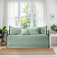 a living room with a couch, rug and window