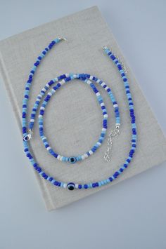 Blue Beaded Necklaces With Letter Beads For Festivals, Blue Beaded Necklace With Letter Beads For Festival, Handmade Blue Amulet Beaded Necklace, Bohemian Blue Evil Eye Jewelry, Bohemian Blue Beaded Necklaces With Evil Eye, Blue Spiritual Necklace With Spacer Beads, Bohemian Blue Necklace With Letter Beads, Blue Spiritual Evil Eye Bracelet With Colorful Beads, Spiritual Blue Evil Eye Bracelet With Colorful Beads