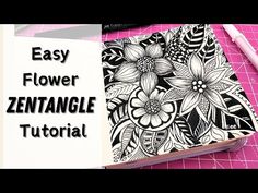 an open notebook with flowers on it and the words easy flower zentanglee in black ink