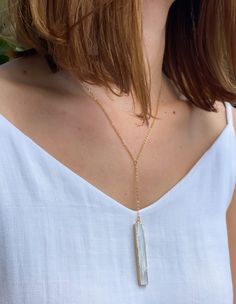 This delicate necklace features a natural selenite crystal wand, 14k Gold Plated dainty 925 Silver chain. Selenite is a calming stone that instills deep peace and is excellent for meditation or spiritual work.

 	Chain: 18K Gold Plated Sterling Silver
 	
Closure: Lobster claw
 	
Style: Boho & Minimalist
 	Model is pictured wearing 18" Dainty White Crystal Necklace With Delicate Chain, White Moonstone Necklace With Delicate Chain, Delicate White Crystal Necklace With Delicate Chain, Everyday Delicate White Crystal Necklace, White Dainty Crystal Necklace With Natural Stones, Dainty White Crystal Necklace With Natural Stones, White Spiritual Jewelry With Delicate Chain, Spiritual White Jewelry With Delicate Chain, Minimalist Long Drop White Necklace