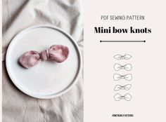 two pink bowknots sitting on top of a white plate