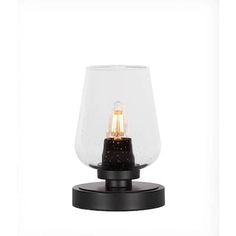 a light that is sitting on top of a wooden stand with a glass vase in the middle