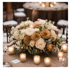 the centerpiece is surrounded by candles and flowers