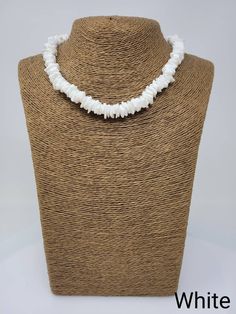 "Black and White Puka shell Necklace. Handmade with white seashell and black wooden beads 17\" Inches Around the neck Handmade Design. Necklace is Unisex Fits Most Sizes FAST SHIPPING! *First Class Mail* Visit my Etsy Shop to see more Designs! Handmade Earrings, Puka Shell Bracelets and Puka Shell Necklaces. Click here to see more designs: https://www.etsy.com/shop/FreedomLifeStyle" White Strand Pearl Necklace For Vacation, Vacation White Strand Pearl Necklace, White Strand Shell Necklace As Gift, White Strand Shell Necklace Gift, White Shell Strand Necklace For Gift, Bohemian White Shell-shaped Pearl Necklace, White Shell-shaped Beaded Necklace For Vacation, White Shell Beaded Necklaces, Adjustable White Pearl Necklace With Natural Stones