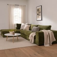 a living room with a green couch and coffee table