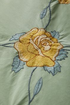 an embroidered rose on a light green sheet