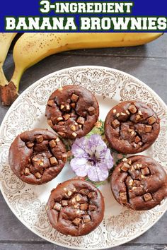 chocolate banana brownies on a white plate with a purple flower