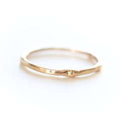 Introducing the original Dainty Ring - a must-have for every ring stack! Made from 14k yellow gold, this ring is both delicate and chic. Wear it alone for a minimalist look or stack it up to create a personalized set. Handcrafted with care, each ring is unique, showcasing its own rustic character. Measuring 1mm in width, this ring is the perfect addition to your jewelry collection. • Please note that Amy will need two weeks to create your ring with utmost attention to detail. Dainty Stackable Rings In Recycled Gold For Promise, Dainty Recycled Gold Stackable Rings For Promise, Dainty Stackable Promise Rings In Recycled Gold, Delicate Everyday Stackable 14k Gold Rings, Adjustable Yellow Gold Stackable Rings With Simple Design, Dainty 14k Gold Stackable Rings, Dainty Recycled Gold Rings With Simple Design, Everyday Delicate 14k Gold Stackable Rings, Delicate Everyday Stackable Round Band Rings