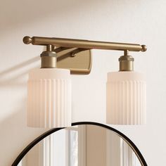 a bathroom light that has two lights on it and a mirror in front of it