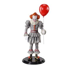 a statue of a clown holding a red balloon