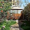 an outdoor gazebo surrounded by trees and flowers