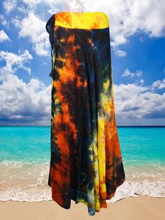 Make a statement with this boldly designed Women Maxi Wrap Skirt. It is hand-dyed and features a one-size wraparound fit for maximum comfort, making it perfect for beach or festival wear. Effortlessly stylish, it adds a unique flair to any wardrobe. This Retro Wrap Maxi Skirt features exotic colorful rayon fabric, perfect for beach or summer outings. It is one size, fitting sizes SML, and handmade with breathable fabrics. With wrap ties and a fun tie dye design, you can look dressy and chic whil Tie Dye Long Skirt, Bohemian Multicolor Silk Sarong, Multicolor Beach Season Sarong Cover-up, Hippie Tie-dye Skirt For The Beach, Casual Tie-dye Beach Skirt, Beach Maxi Skirt, Multicolor Cotton Sarong For Beach Cover-up, Long Wrap Skirt, Rayon Skirt