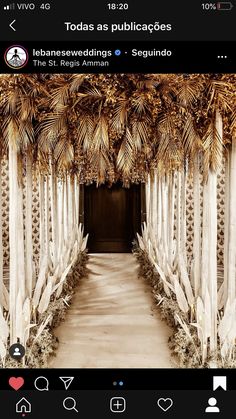 an elaborately decorated wedding aisle with gold and white flowers on each side, surrounded by tall columns