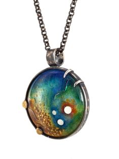 gold and silver cloisonne enamel jewel pendant Unique Gold Enamel Jewelry, One-of-a-kind Celestial Jewelry Gift, Gold Patina Pendant Jewelry, Gold Pendant Jewelry With Patina, Patina Sterling Silver Jewelry Gift, Unique Patina Jewelry With Round Pendant, Enamel Cabochon Round Pendant Jewelry, Sterling Silver Patina Jewelry For Gift, Artistic Gold Jewelry With Cabochon