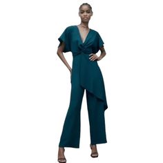 Zara Crossed Ruffled Jumpsuit In Dark Teal V-Neck Jumpsuit With Short Sleeves. Front Knot And Ruffle. Wide Leg. Back Zip Closure. Size Xs -- Pit To Pit 14", Inseam 29" -- 100% Polyester Brand New W/ Tag! 2/26/24-1 Elegant Blue Jumpsuits And Rompers With Ruffles, Elegant V-neck Ruffled Jumpsuits And Rompers, Zara Green V-neck Jumpsuits And Rompers, Blue V-neck Jumpsuit With Ruffles, Chic Blue V-neck Pantsuit, Elegant Blue Zara Jumpsuits And Rompers, Chic Zara V-neck Jumpsuits And Rompers, Zara Summer Evening Pantsuit, Elegant Blue V-neck Jumpsuits And Rompers