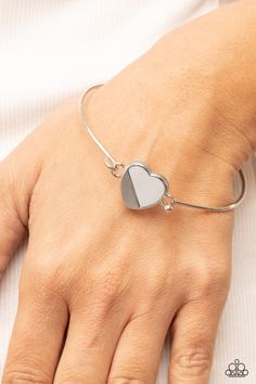 A glistening silver plate slants across a white shell-like heart charm that delicately hinges to a dainty silver bangle-like bracelet, creating a charming centerpiece around the wrist. Features a barbell closure. Sold as one individual bracelet. Squirrel Jewelry, Intention Bracelets, Hook Bracelet, White Bracelets, Paparazzi Accessories, Gold Bangle, Silver Bangle, Affordable Jewelry, Paparazzi Jewelry