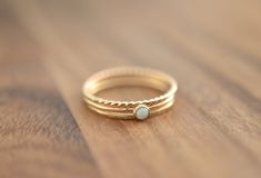 Beautiful birthstone stacking stone ring. Set of 3 rings one opal, one rope ring, and one hammered ring. Made in 14k gold filled and stone is a 3mm simulated opal. Also available in rose gold: https://www.etsy.com/listing/597957197/rose-gold-opal-ring-set-14k-rose-gold?ref=listing-shop-header-3 This ring is made to order in your size. If you don't see your size available please feel free to message me. All orders ship in a gift box. If you are ordering multiple items and want them boxed separate Adjustable Opal Stackable Rings, Gold Opal Ring, Opal Stacking Ring, October Birthstone Ring, Rope Ring, Multiple Rings, October Birthstone Rings, Rope Rings, Hammered Ring