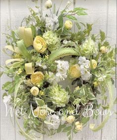 a wreath with yellow and white flowers hanging on a door frame that says net nest bows