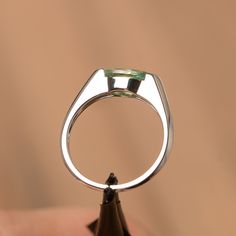 It is a green sapphire ring. The main stone is 5 mm*10 mm marquise cut.weight about 1.34 carats. The basic metal is sterling silver and plated with rhodium/14k white gold/14k rose gold/14k yellow gold You can also go to my shop Home for more elegant rings: https://www.etsy.com/shop/godjewelry?ref=hdr_shop_menu Customization is always welcome and please feel free to contact with me if you have any design ideas! Modern Green Jewelry With Prong Setting, Modern Marquise Cut Gemstone Jewelry, Modern Marquise Cut Promise Ring Jewelry, Sterling Silver Solitaire Jewelry, Marquise Cut, Modern Marquise Cut Jewelry With Prong Setting, Modern Jewelry With Marquise Cut And Prong Setting, Modern Marquise Cut Gemstone Rings, Modern Jewelry With Prong Setting And Marquise Cut, Modern Marquise Sterling Silver Jewelry