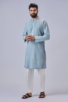 Light blue kurta with multi colored thread embroidery. Comes with pyjama pant.
Components: 2
Pattern: Embroidered
Type Of Work: Thread Work
Neckline: Mandarin
Sleeve Type: Straight Full
Fabric: Cotton Silk
Color: Blue
Other Details: 
Closure: Front button placket
Occasion: Mehendi and Puja - Aza Fashions Blue Kurta, Kurta Men, Silk Kurta, Kurta With Pants, Thread Embroidery, Fashion App, Cotton Pyjamas, Thread Work, Kurta Set